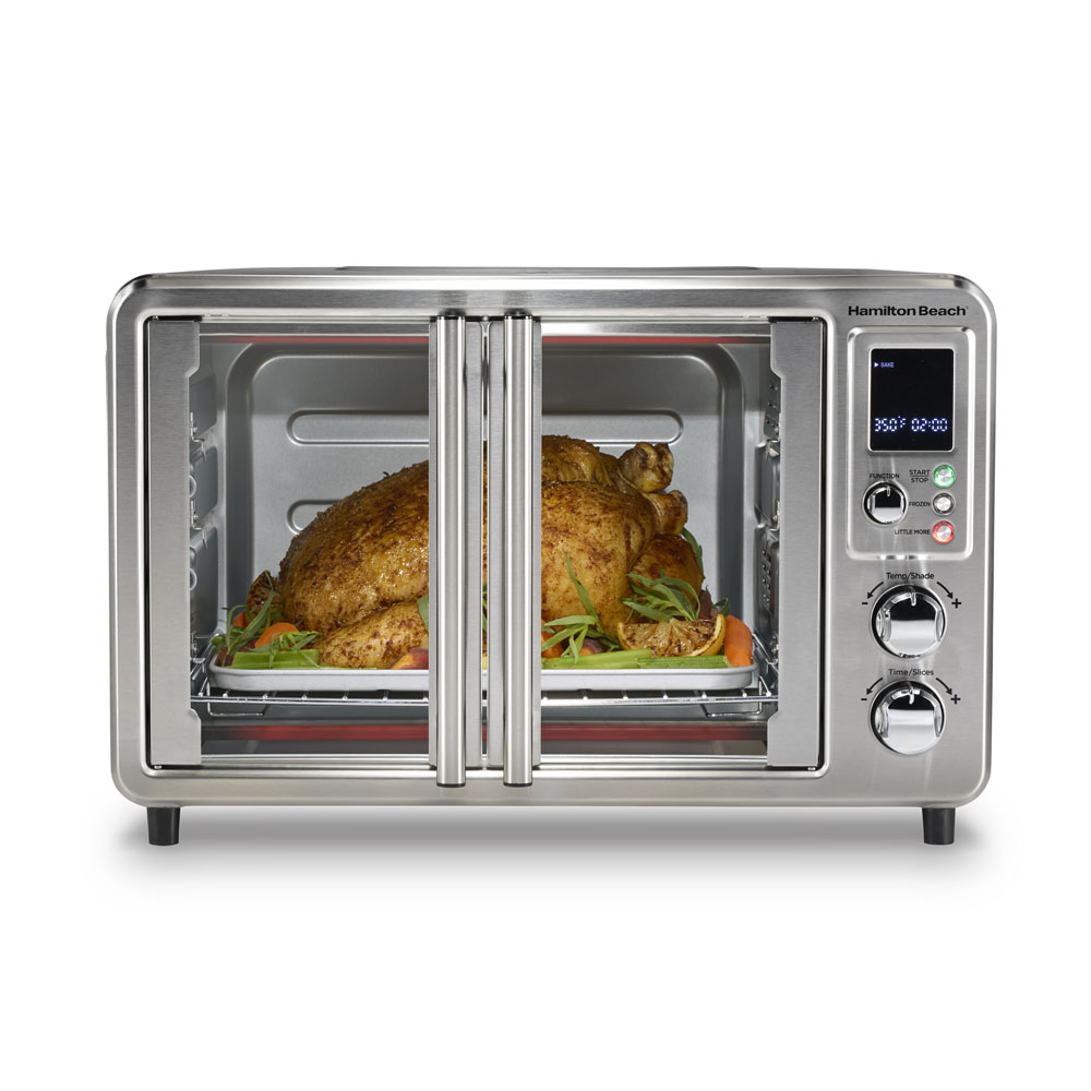 Hamilton Beach 31188J single-cavity countertop oven with side-opening French doors, digital controls and a staged chicken meal