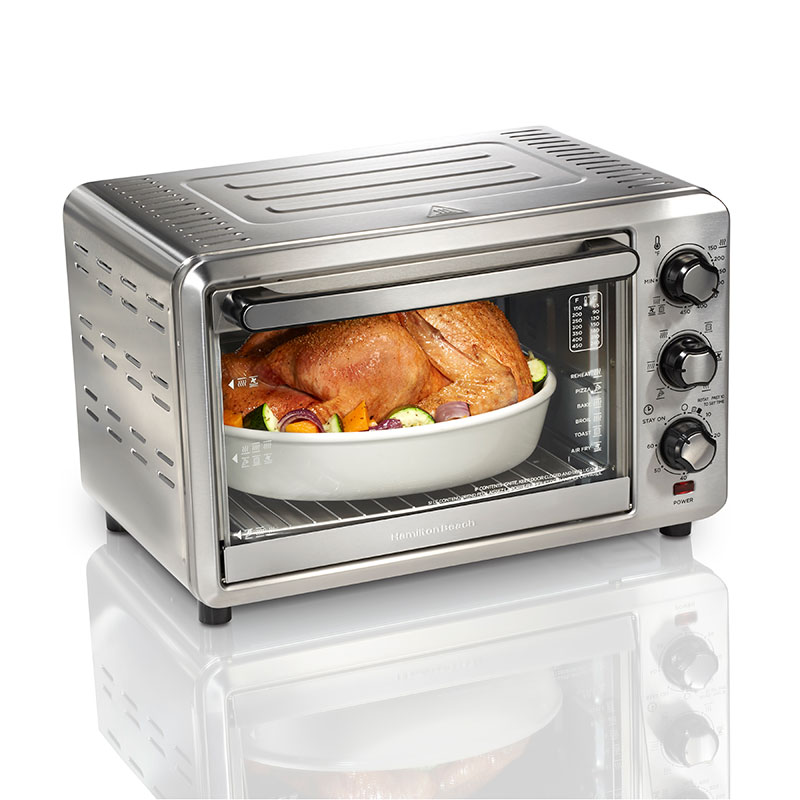 Hamilton Beach Sure-Crisp Air Fryer Toaster Oven 31196FG in a three-quarter front view, showing a silver-and-black single cavity and three manual dials