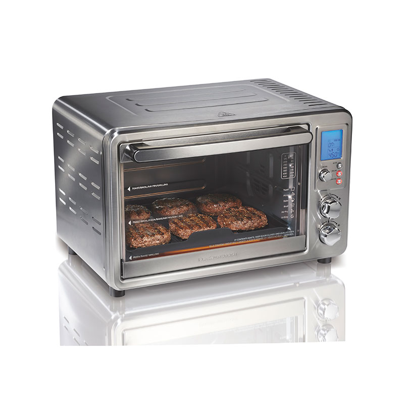 Hamilton Beach standard model 31395 silver Sure-Crisp Air Fry and Grilling single-cavity countertop oven, with digital display, three rotary controls and staged food visible behind the glass.